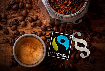 Fairtrade-Siegel und Paragraphenzeichen. Bild: TransFair e.V. / dreimalig Köln